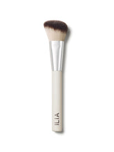 A close-up of the Sculpting brush with a white handle and angled, dual-toned bristles.